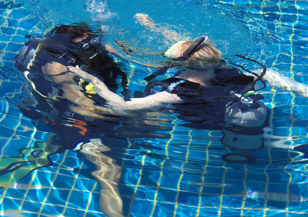 Scuba students practising equipment skills in a pool