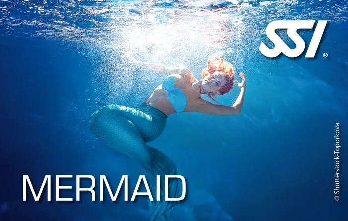 SSI Mermaid student gliding through the crystal-clear sheltered shallow water at Khao Lak, Thailand wearing a colourful mermaid tail