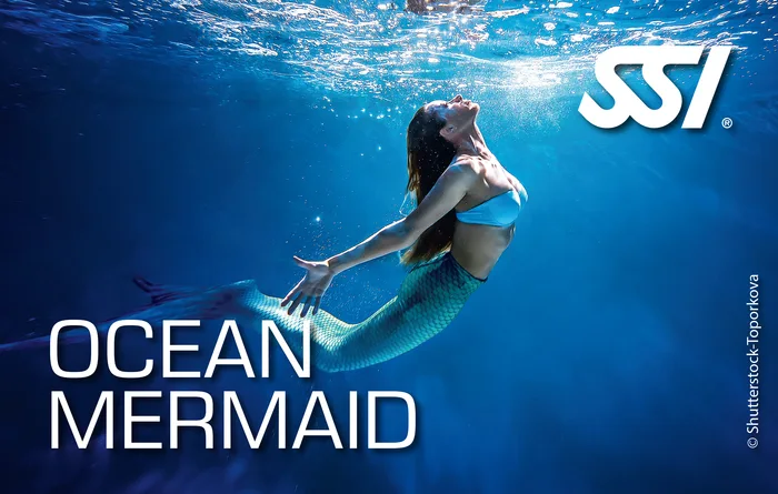 SSI Ocean Mermaid student swimming over a coral reef in the Andaman Sea, Thailand with a colourful mermaid tail