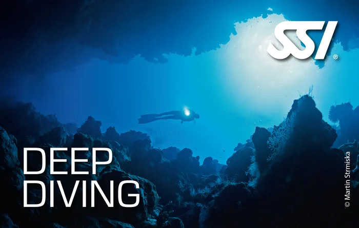 Scuba diver exploring a deep coral wall in the Andaman Sea, Thailand during an SSI Deep Diving specialty course